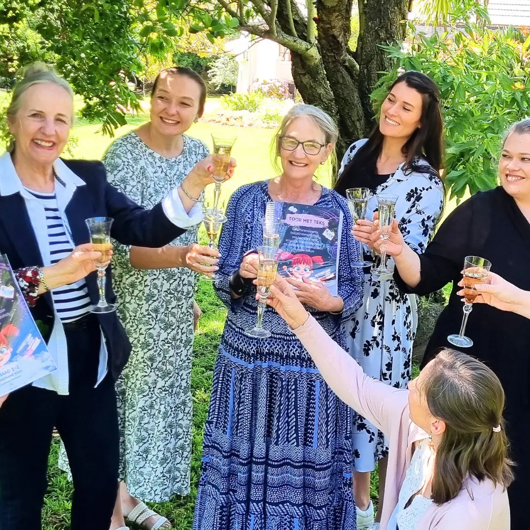 Educators toasting the launch of a Yellow Tree resource outdoors