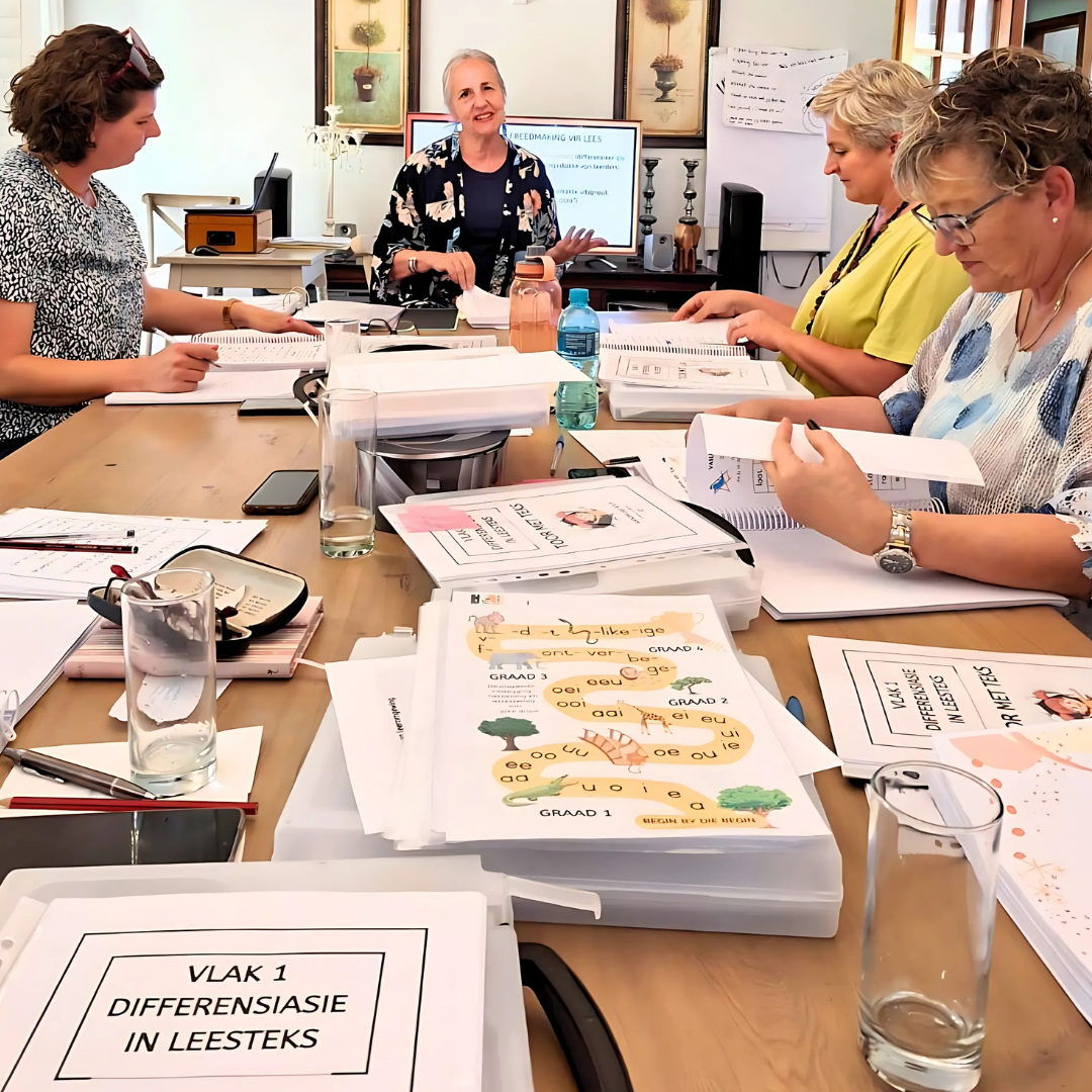 Teachers working through Yellow Tree reading materials at a training session