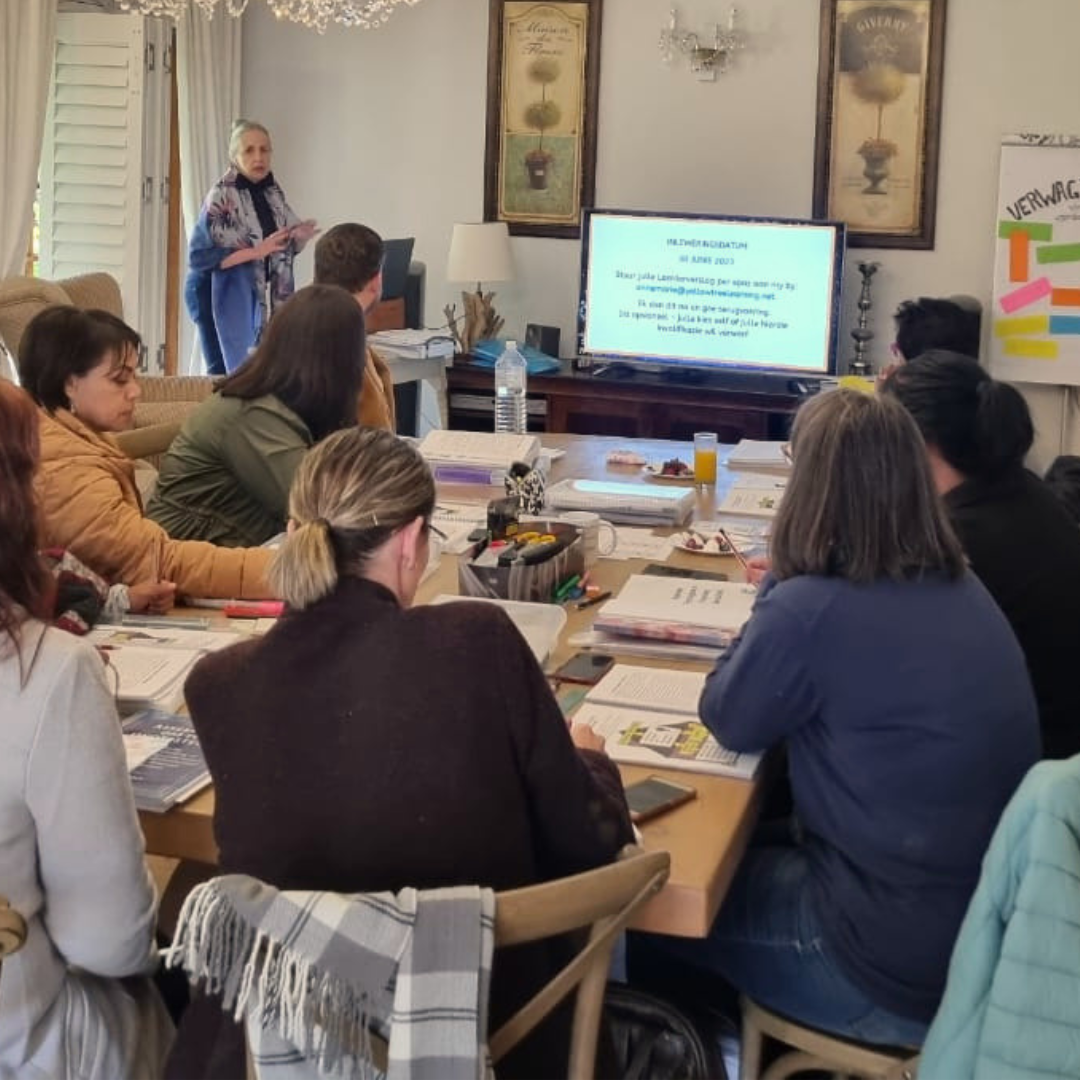 Annemarie presenting to a full table of educators at a workshop