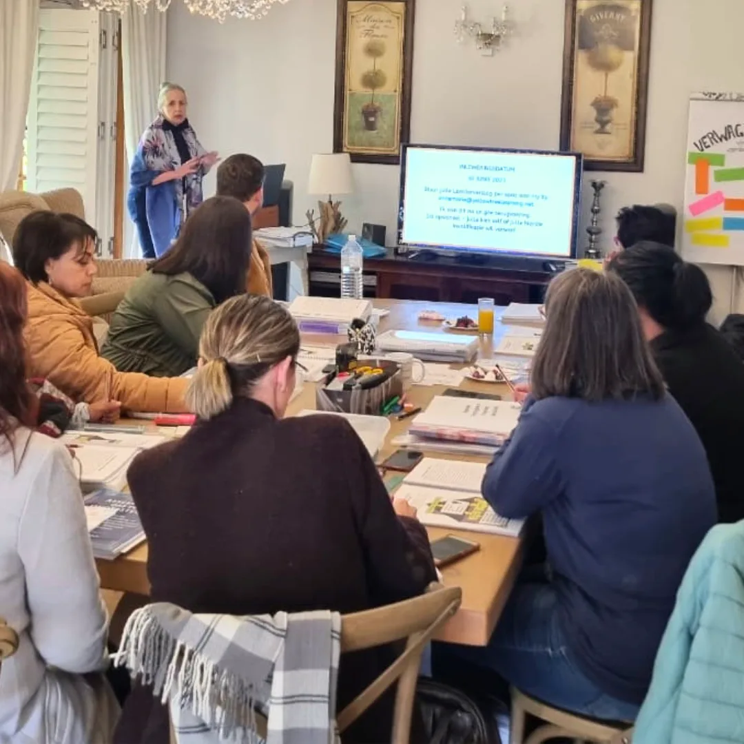 Educators seated around a table taking notes at a Yellow Tree training workshop