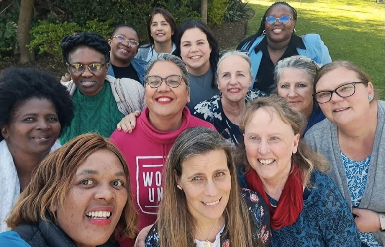 The Yellow Tree community of educators and supporters photographed together outdoors